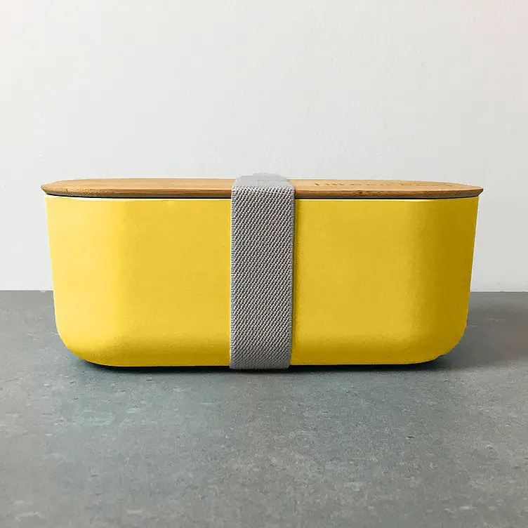 https://www.greenerlyfe.com/wp-content/uploads/2021/07/bambox-microwavable-bamboo-lunch-box-1-1L-yellow-grey-strap-side.jpg